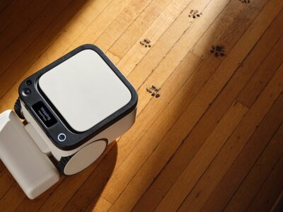 Matic robot vacuum on a wooden floor with pet paw prints, mapping the room on-device