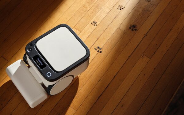 Matic robot vacuum on a wooden floor with pet paw prints, mapping the room on-device