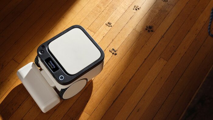 Matic robot vacuum on a wooden floor with pet paw prints, mapping the room on-device